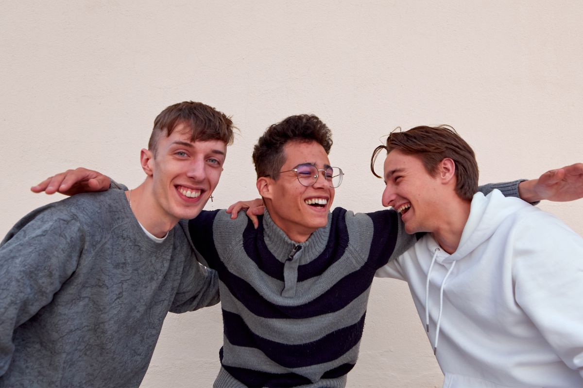 Three young men smiling and laughing