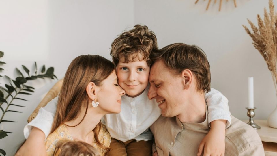 Is OCD Genetic a teen boy with his family looks at the viewer considering the genetics of his condition.